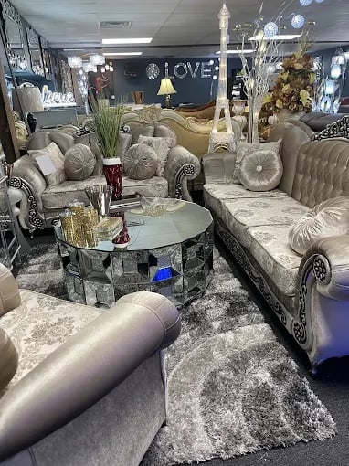 Elegant living room furniture display with plush sofas and decorative round coffee table