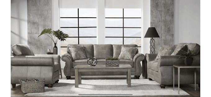 Modern gray living room with sofa, armchairs, and decorative elements